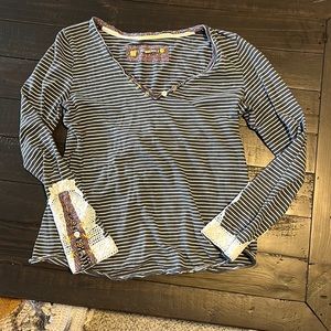 Cute striped tee with lace detailing.